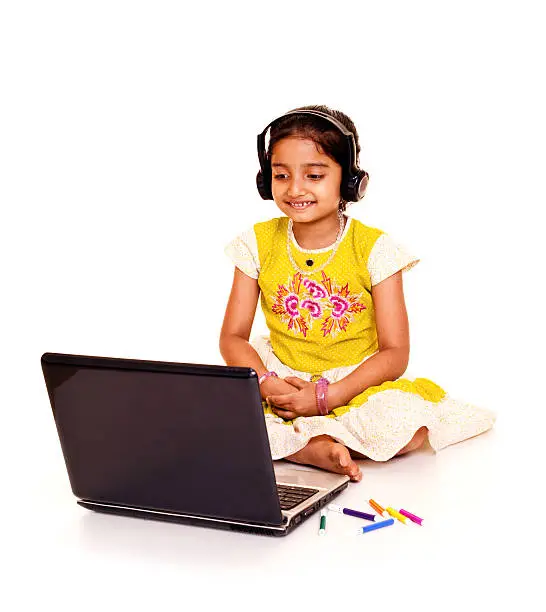 Photo of Cheerful Little Indian Girl Using Laptop Isolated on White Background