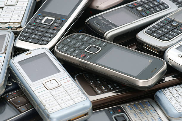istock Old used cellphones pile as background 184328356