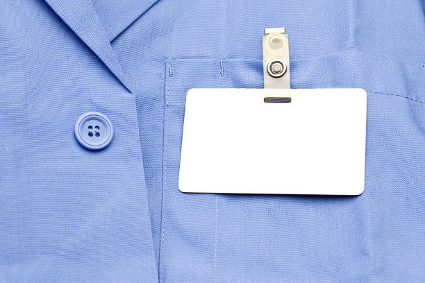 Name Tag on shirt Blank Name tag on blue shirt. metal clip stock pictures, royalty-free photos & images