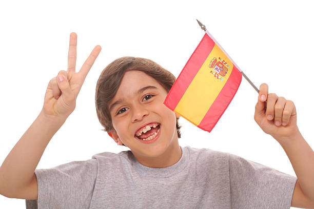 A boy energetically waves Indonesian flags,his mouth open in a shout of excitement.His enthusiasm and patriotic spirit make this image Perfect for Indonesian Independence Day, and national events.