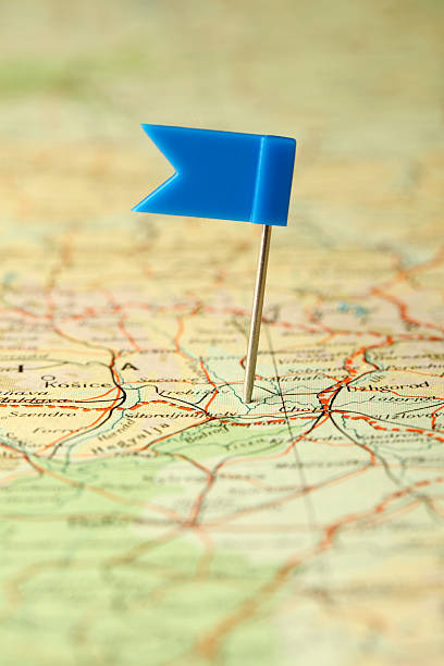 istock A blue flag pin stuck to a tan road map. 184329377