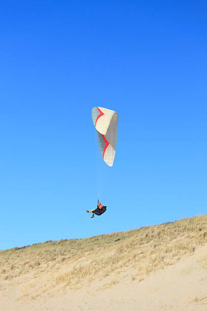 istock Paraglider in action against blue sky 184329402