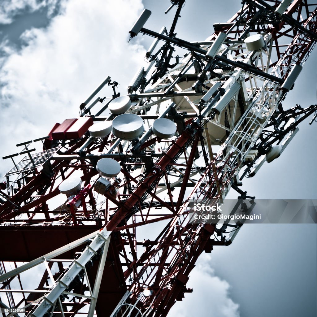 Communications Tower Communications tower on cloudy sky. Antenna - Aerial Stock Photo