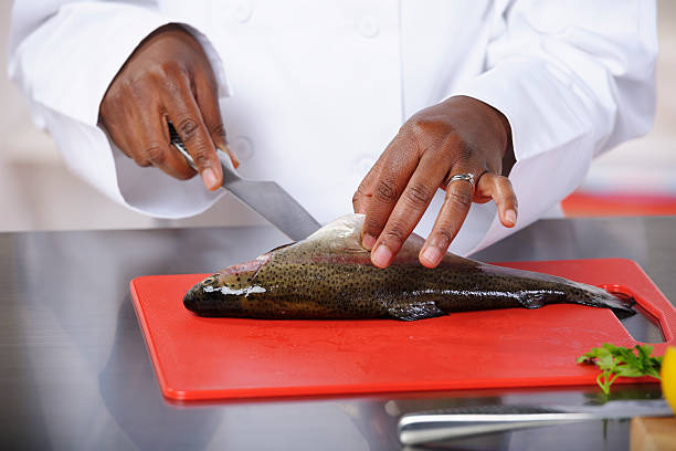 istock African American Chef Preparing Fish In A Commercial Kitchen 184329640