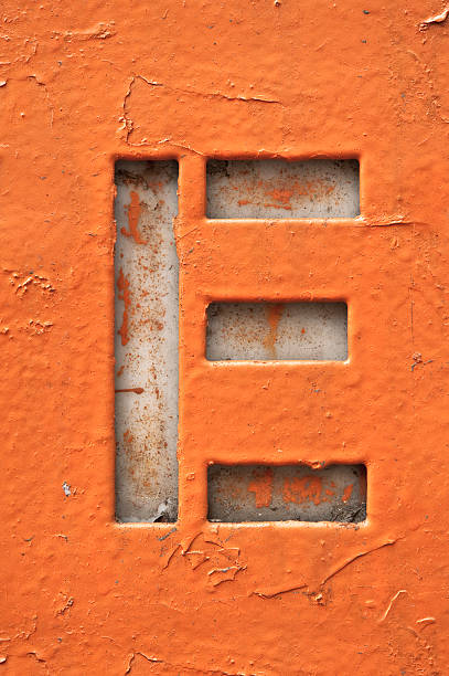 Cut out of the letter E in grunge style Painted metal grunge letter E capital letter photos stock pictures, royalty-free photos & images