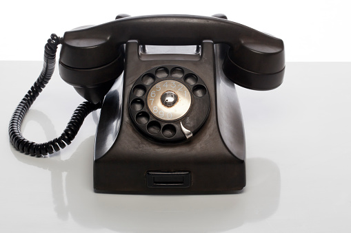Old-fashioned phone - telephone isolated on a white background.