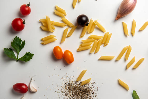 Top view of healthy, antioxidant group of food shot on white background. The composition includes food rich in antioxidants considered as a super-food like onion, tomato, paprika, garlic, salad, mint, olives and arugula.
