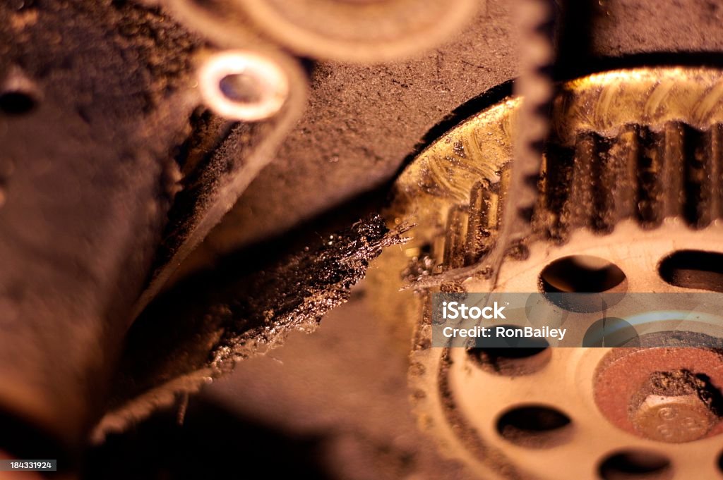 Broken Timing Belt "A broken timing belt on a grungy 4-cylinder engine.  It should have been replaced a long time ago, but the owner didn't take very good care of their vehicle so it left them sitting on the side of the highway.All images in this series..." Timer Stock Photo
