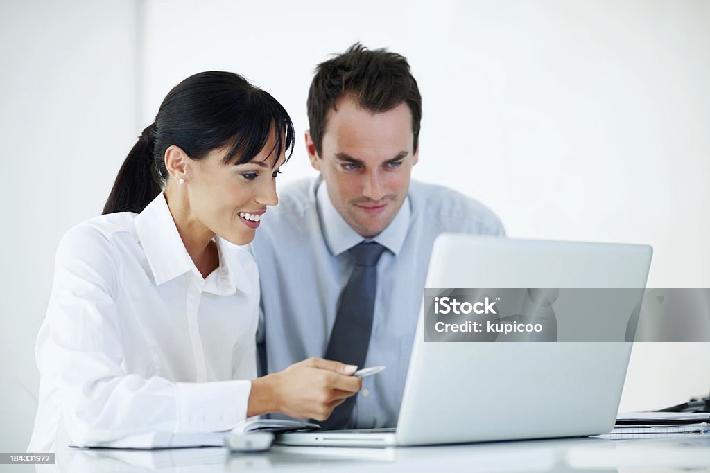 Business people with laptop at office Business woman pointing at laptop and explaining plan of work to colleague 30-39 Years Stock Photo