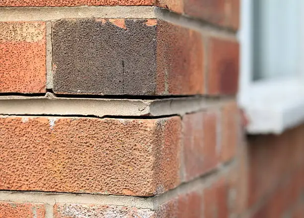 Photo of Foundation problems causing house bricks to part.