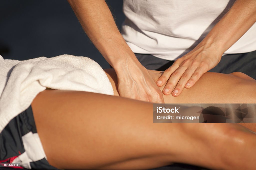 Sports massage Sport therapist massaging leg of an athlete Massaging Stock Photo