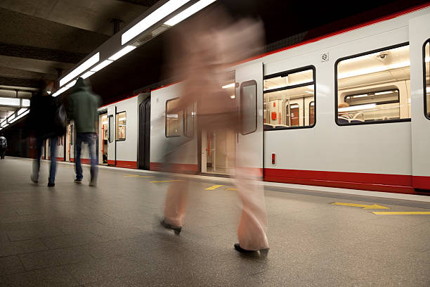 Woman in Pink Walking on Subway Platform