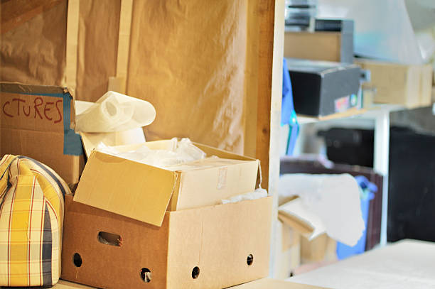 Messy storage area Storage area full of boxes and bags. It is an attic but could be any room before clearing out or moving house. attic stock pictures, royalty-free photos & images