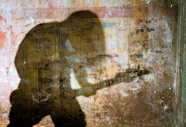 Grunge wall Grunge wall with the shadow of playing guitarist. alternative rock stock pictures, royalty-free photos & images