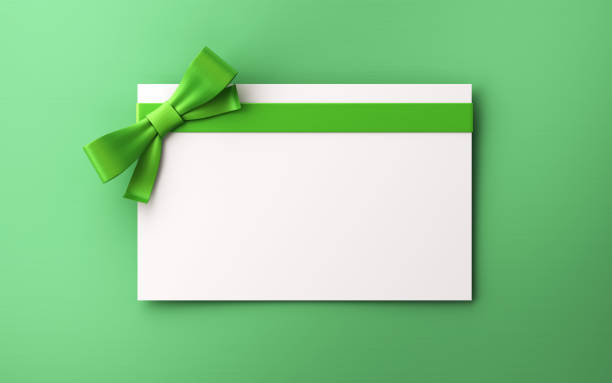istock Gift Cards With Green Colored Bow on green background 1843356686