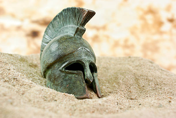 Fallen Greek helmet Greec helmet in sand sparta greece photos stock pictures, royalty-free photos & images