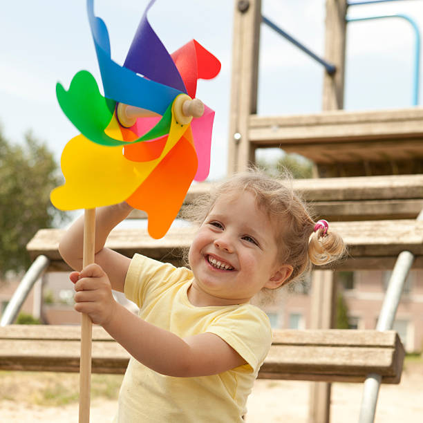 istock Preschooler looking at pinwheel. 184335710