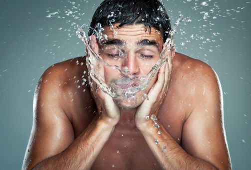 Portrait of man washing face.Motion blur