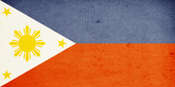 Close-up on a paper flag of Philippines with light effect and vignette. Visible paper texture for super realistic effect. Selective focus. Canon 5D Mark II and Sigma lens.SEE MORE STATE FLAGS BELOW: