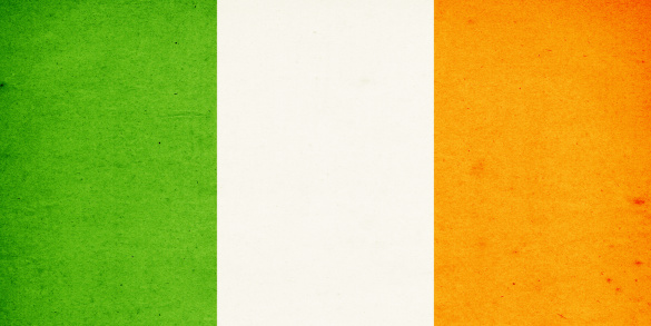 Close-up on a paper flag of Ireland with light effect and vignette. Visible paper texture for super realistic effect. Selective focus. Canon 5D Mark II and Sigma lens.SEE MORE STATE FLAGS BELOW: