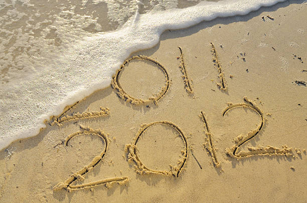 istock New Year 2012 Written in the Sand W Wave 184337005