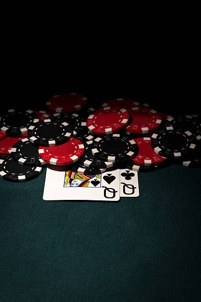 istock Pocket Queens with red & black poker chips 184337086