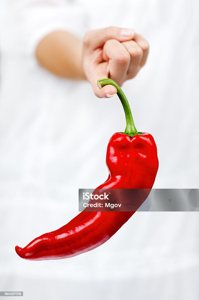 Red Chilli Pepper Red Chilli Pepper hanging on a finger. Chili Con Carne Stock Photo
