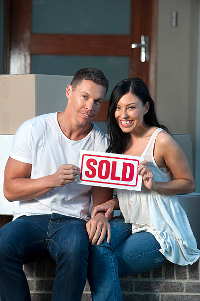 istock Couple holding a sold sign 184337486