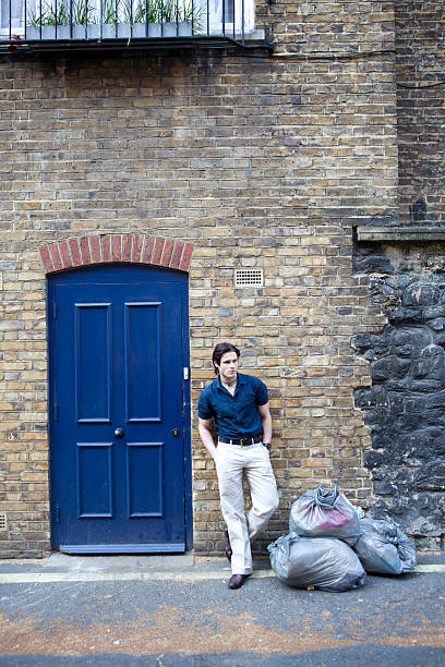 istock Handsome Young Man Outside Urban Apartment Vertical 184338943