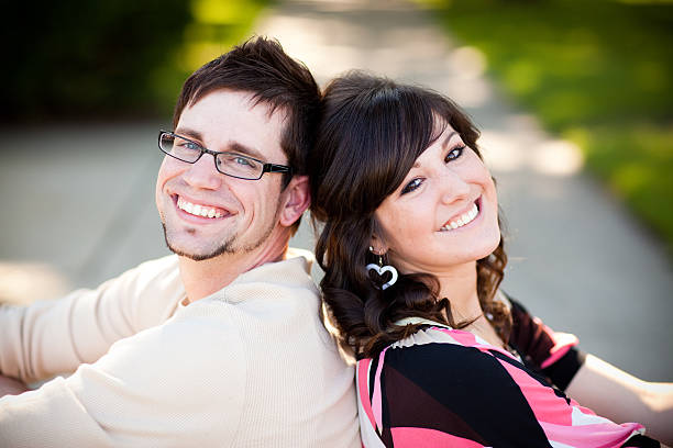 istock Happy, Young Couple Sitting Together Outside 184339600
