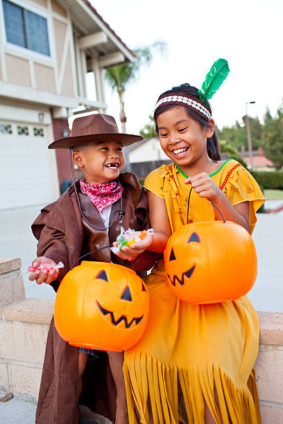 istock girl and boy laughing at their candy 184339876