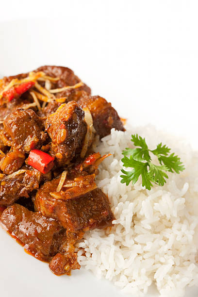 Delicious rich meaty 'Gang Hang Lay', traditional Shan Burmese pork curry made with ginger and peanuts. Here it is served with fresh steamed Jasmine rice. This curry dish is famous in Myanmar but also is known as a typical dish of Northern Thailand, where it is very popular. 