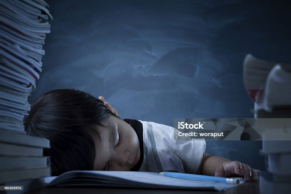 Homework Photo of a little boy sleeping with his homework. 2-3 Years Stock Photo