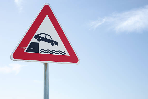 istock Car falling in water warning traffic sign 184341108