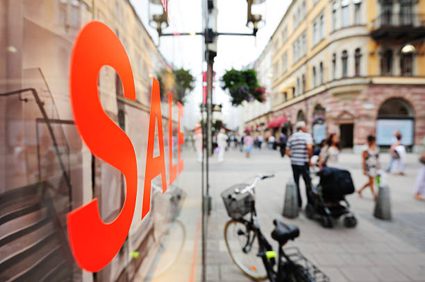 Shallow DOF picture of shop sale, street and shop out of focus in background.