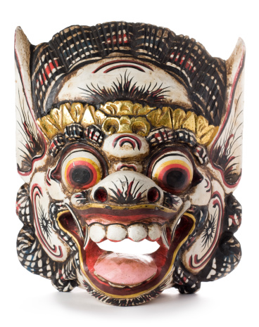 A Balinese Barong mask isolated on a white background.