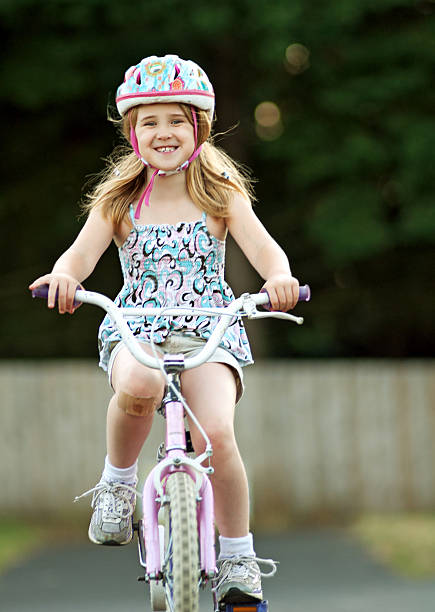 rapariga bicicleta de equitação - helmet bicycle little girls child imagens e fotografias de stock