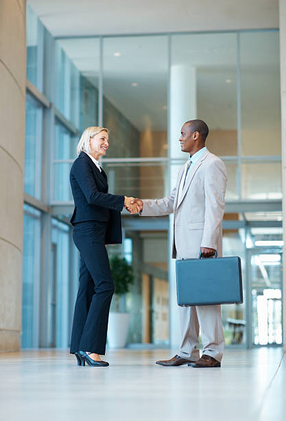 istock Happy business people shaking hands with each other 184342581