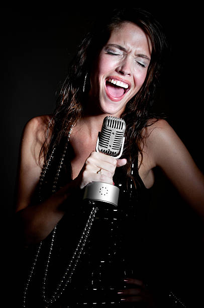 istock Young Female Caucasian Singer Isolated on Black 184343038