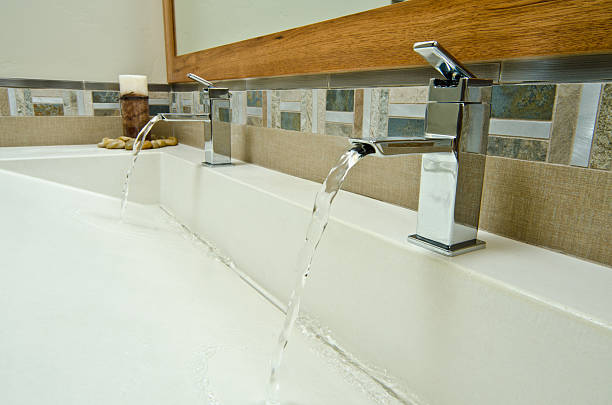 Close up of bathroom sinks These two bathroom sinks shows how the water runs. bathroom sink photos stock pictures, royalty-free photos & images
