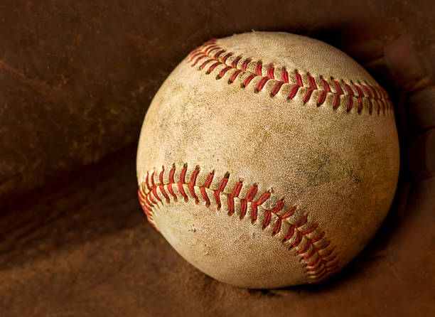 istock Used Baseball Inside of a Glove 184343355
