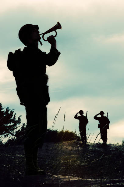 istock Silhouette of WWII  Soldier Playing Taps  At  Days  End 184343410