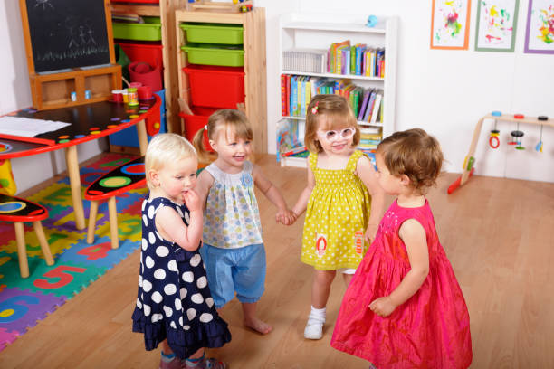 Two Little girls with down syndrome playing with a friend.  Photo was taken in Quebec Canada.