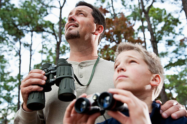 istock Father and son enjoying scenic view with binoculars 184343568