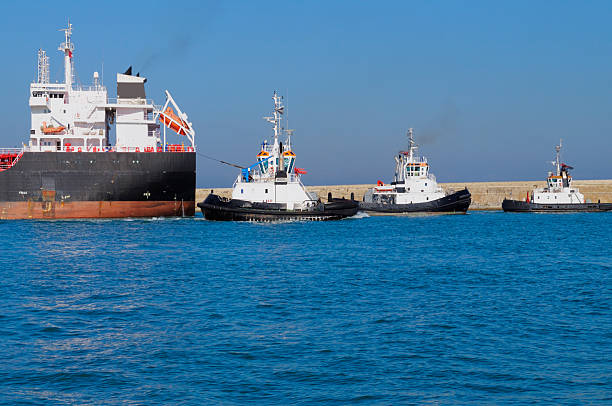istock Cargo Ship and Tugboats 184345164