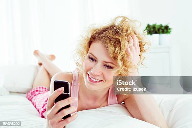 Using Cell Phone In A Bed Stock Photo - Download Image Now - 20-24 Years, 25-29 Years, Adult