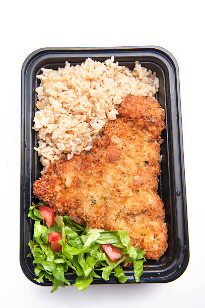istock Chicken Schnitzel with brown rice and salad 184345585
