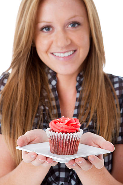 istock Beautiful Young Woman Holding Cupcake on White Background 184345800