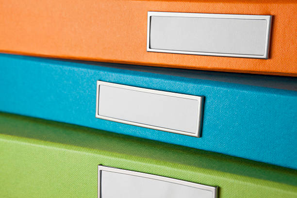 Three colorful file boxes stock photo