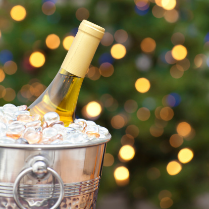 Closeup of a Wine Bottle In Front of Christmas Tree.